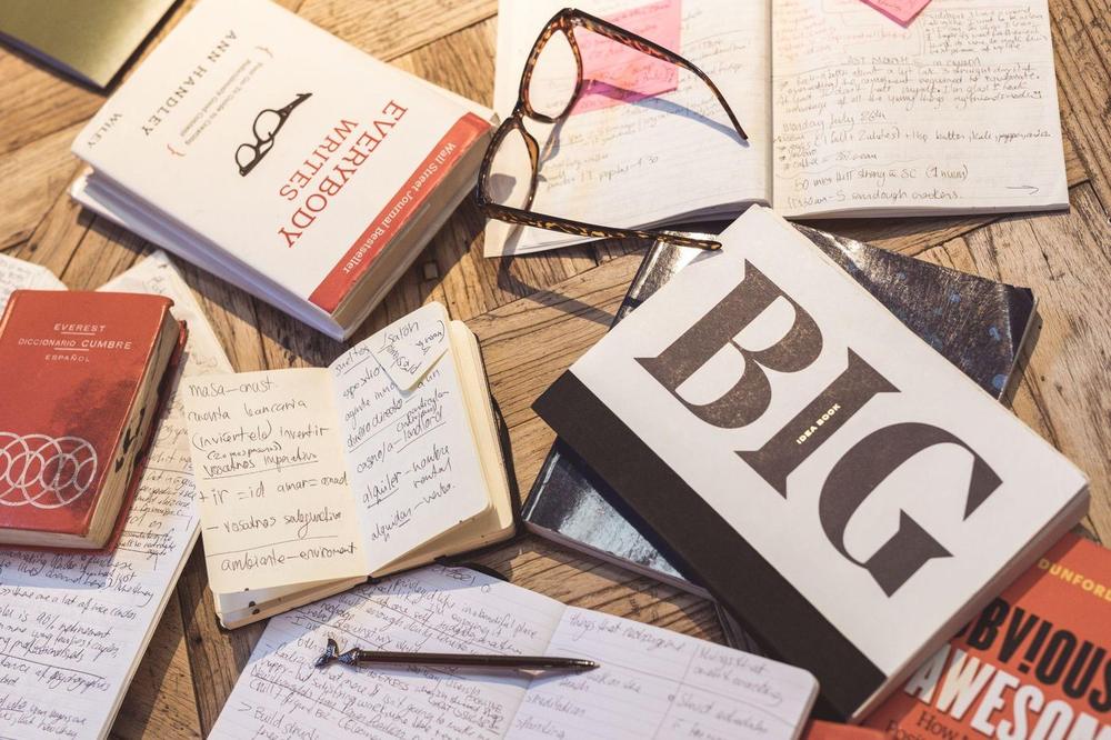 Notebooks, glasses and marketing books